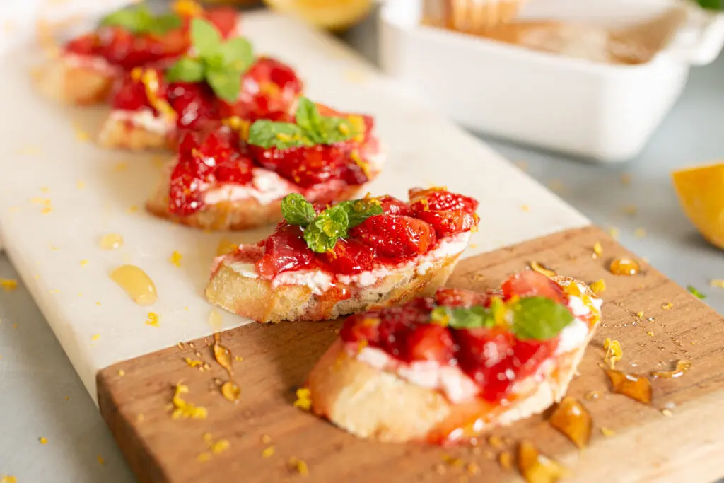 Sweet Strawberry Bruschetta close up on wooden plank