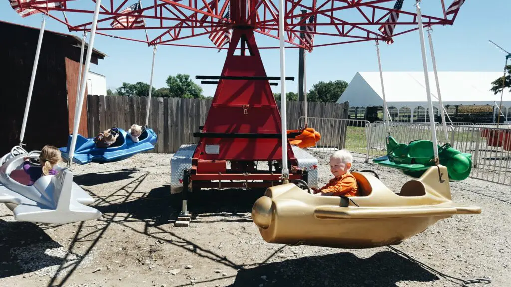 Carnival Rides at Millstadt Farm. Kiddie ride airplane.