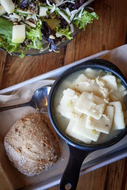 Chicken N Dumplings at Eckert's Restaurant with scone and side salad on platter.