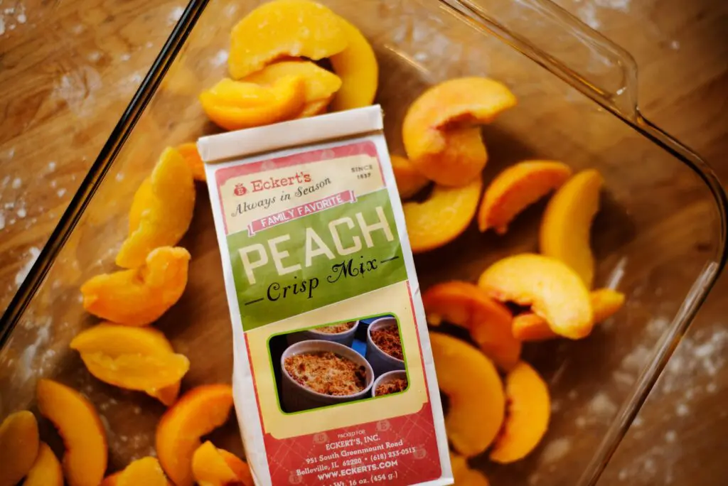 A picture of Eckert's peach crisp mix on top of sliced peaches