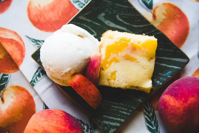 Grandma Ruth's Peach Cake plated with decorative peach cloth.
