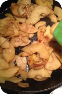 A picture of sauteed apples in cast iron skillet.