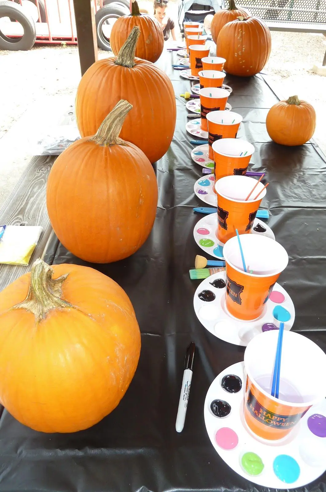 Pumpkin Painting set up with pumpkins and paint on outdoor table