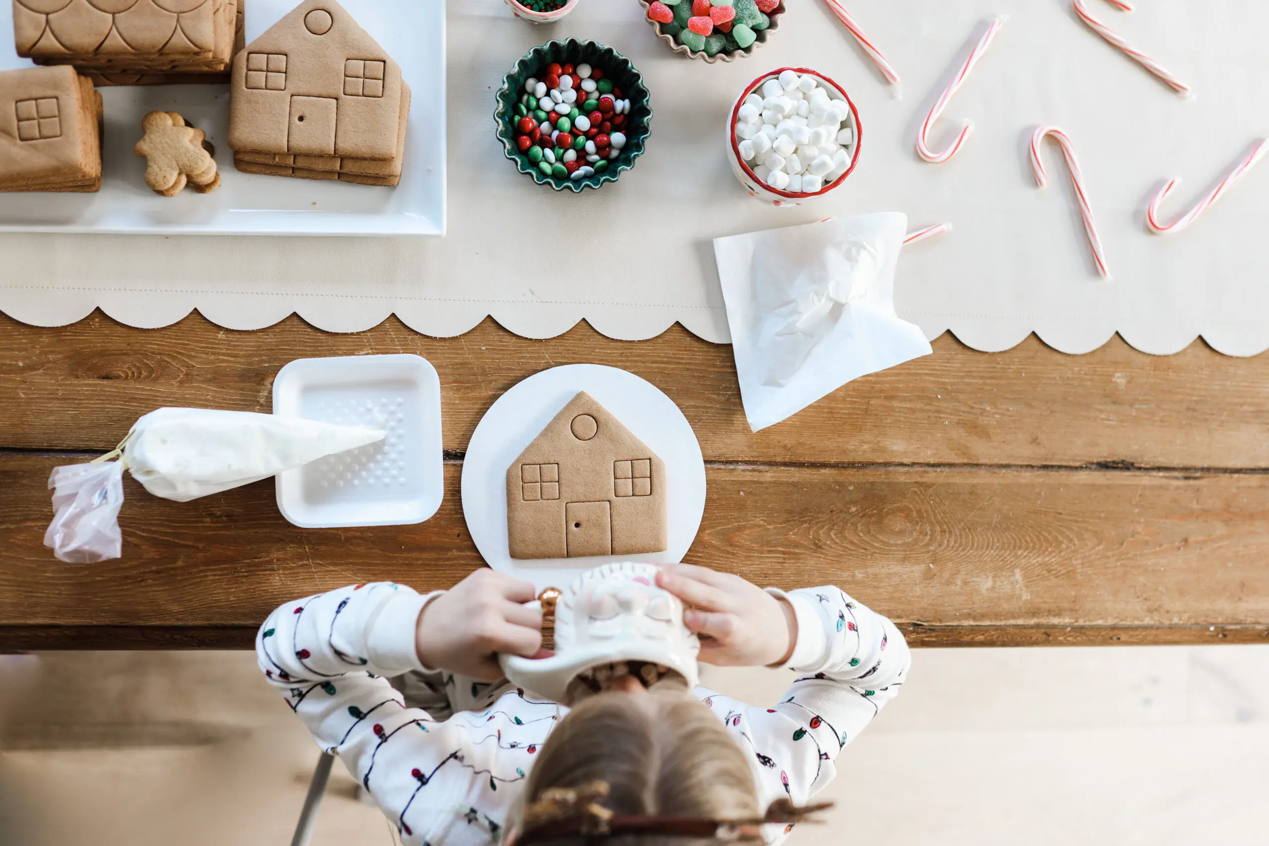 Gingerbread House Making- girl with gingerbread house to assemble