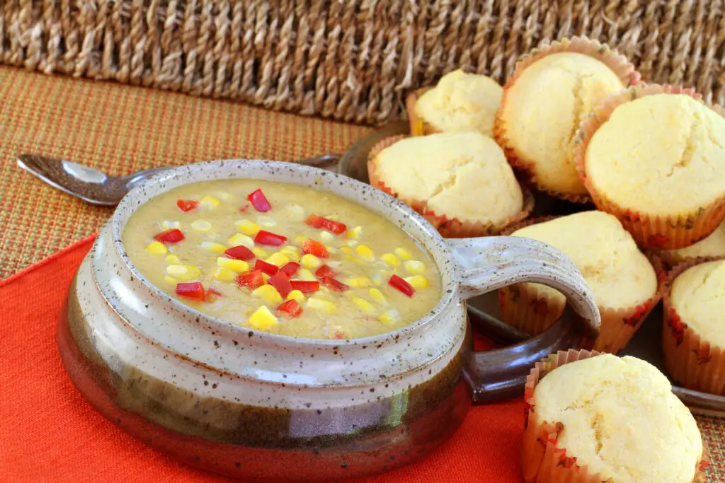 Easy Corn Chowder Recipe for Winter - soup in ceramic bow with fresh muffins.