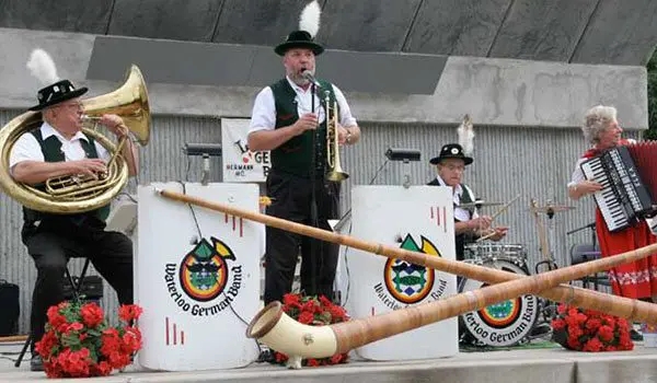 Cider Shed Live Music: Waterloo German Band. A traditional German band performs with instruments including a tuba, alpenhorn, drums, and accordion.
