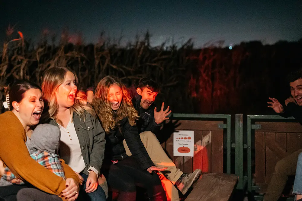 Millstadt Haunted Hayride. Dark theme with people laughing and screaming
