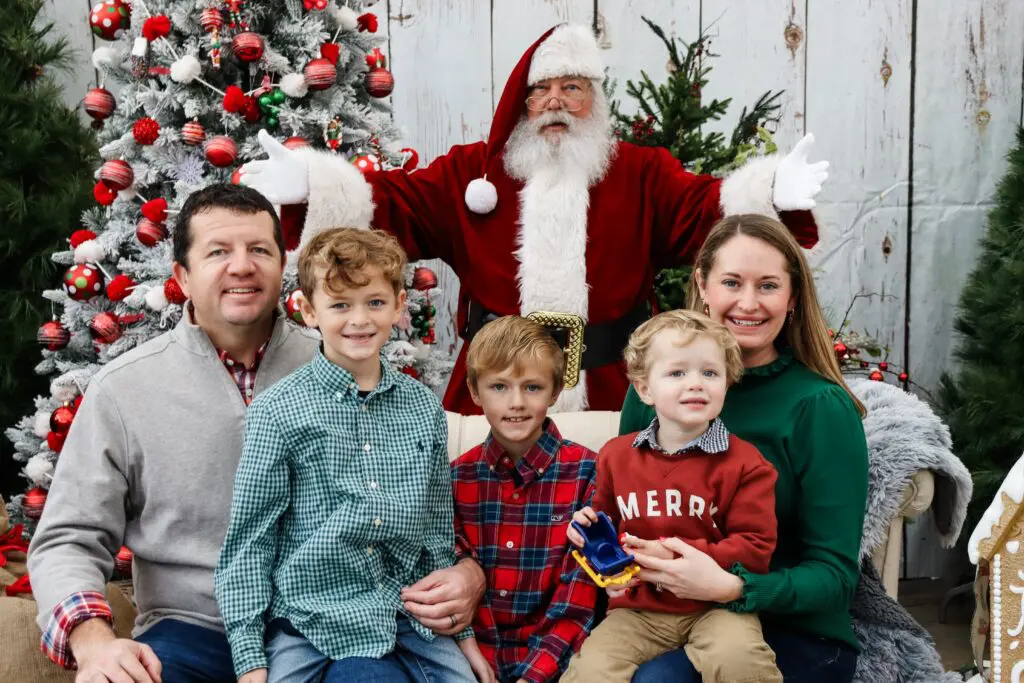 Mom, Dad & three kids posed with Santa. Photos with Santa