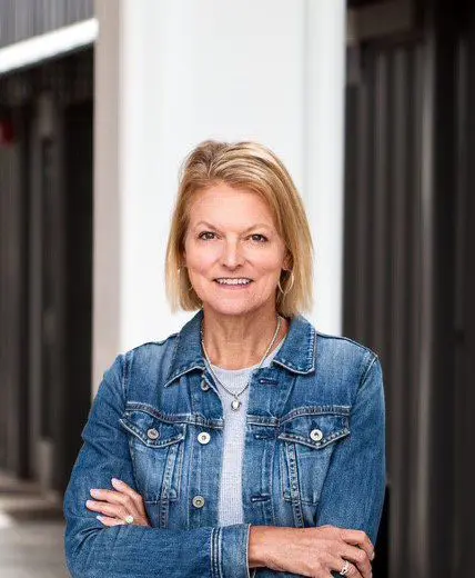 Angie Eckert upper body photo with jean jacket indoors