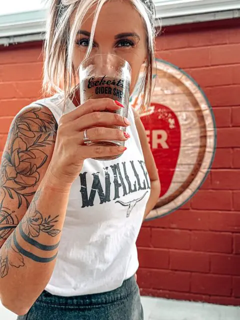 Cider Shed; woman drinking a pint of cider