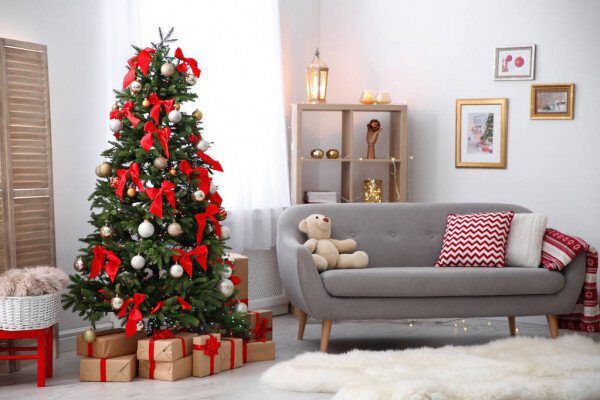 A picture of a living room with a decorated Christmas tree