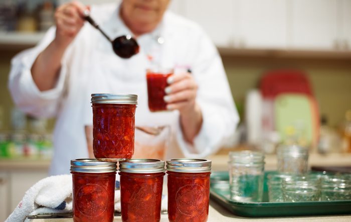 A picture of a man jarring Eckert's strawberry freezer jam