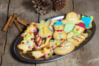 Cookies and Christmas decorations on wooden table